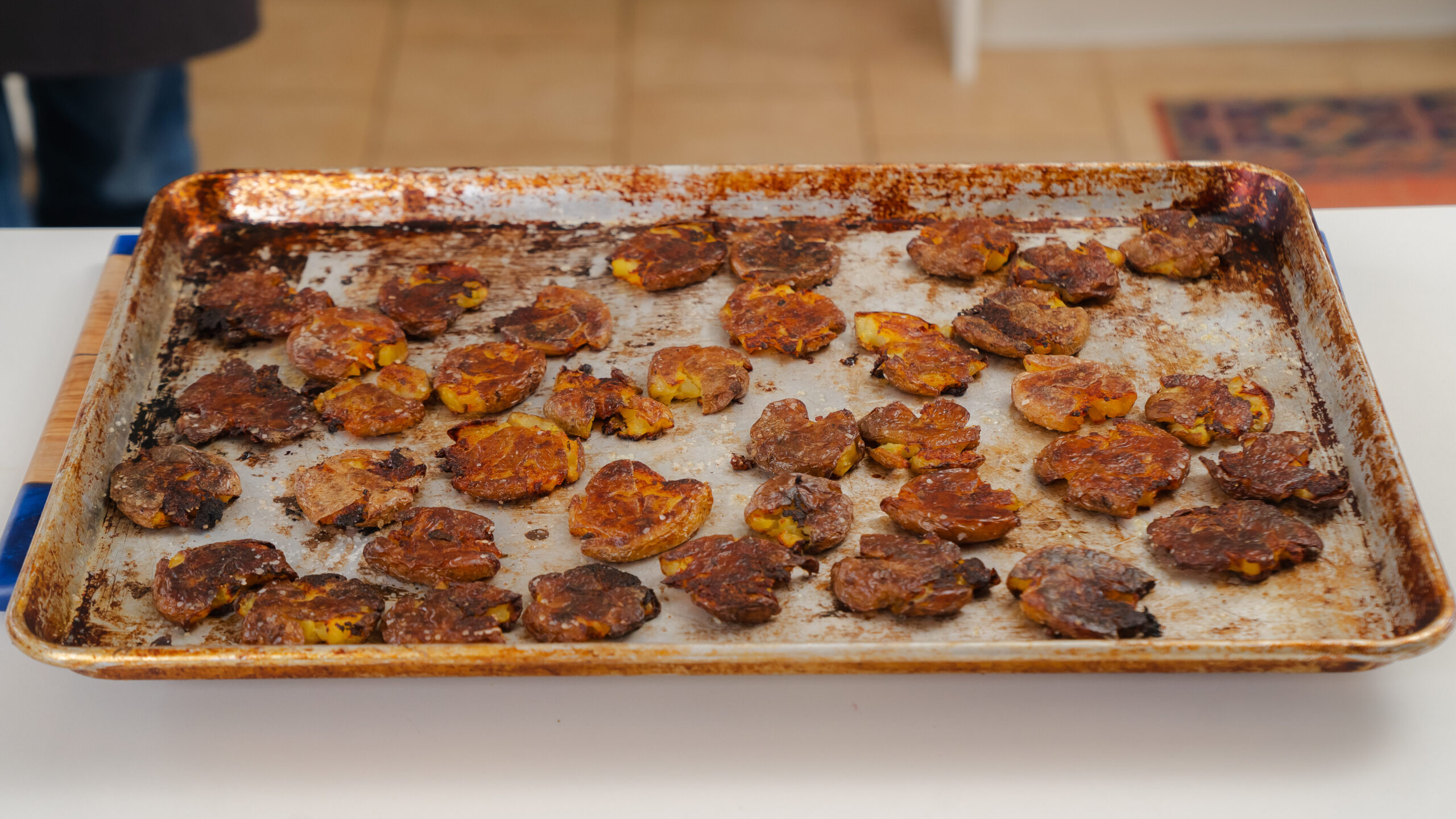 Smashed potatoes on a cooking sheet, just out of the oven.