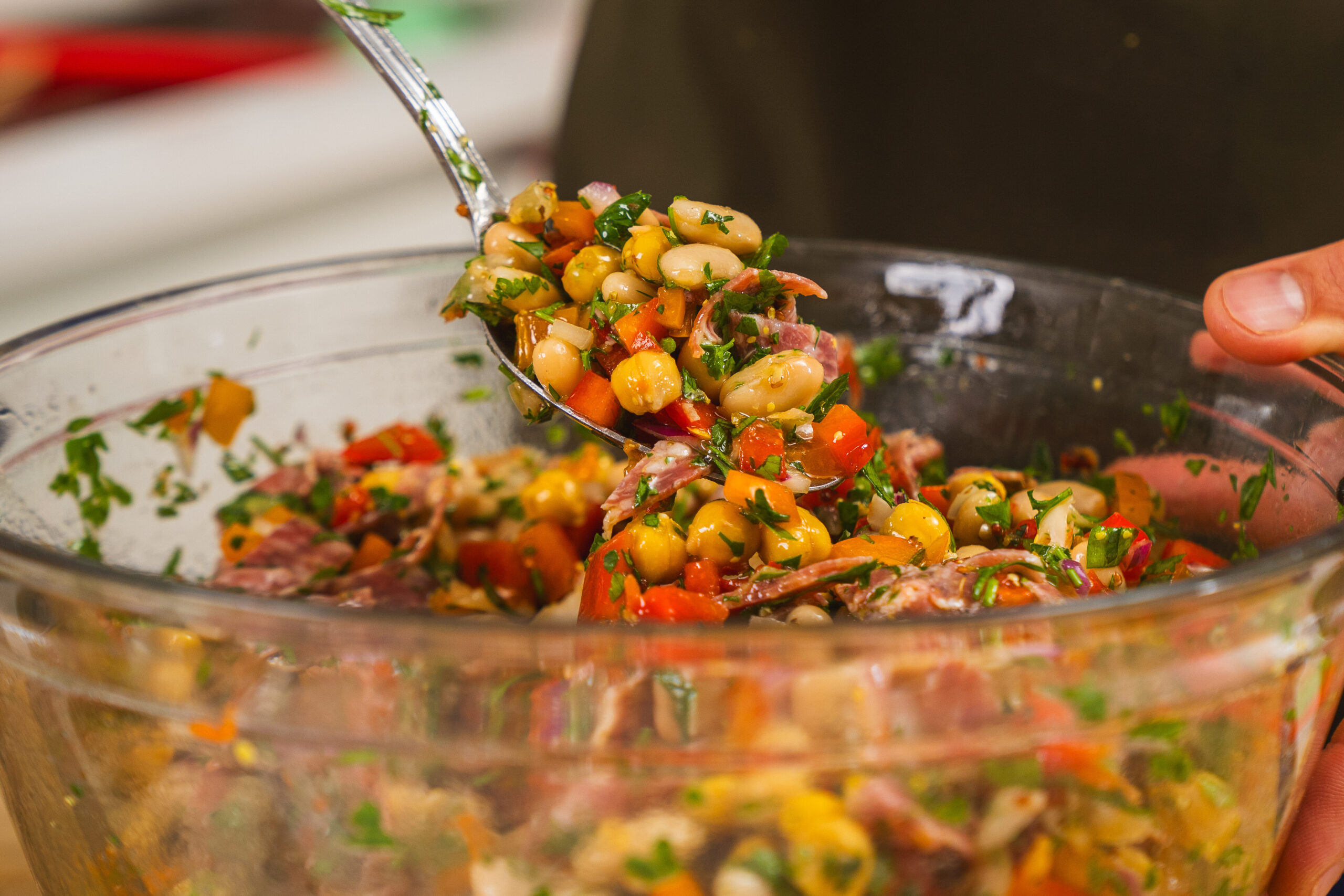 La Scala salad in a large bowl being tossed.