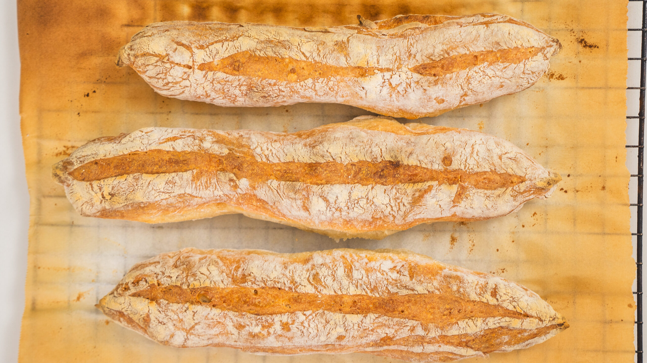 Homemade baguettes on a cutting board.