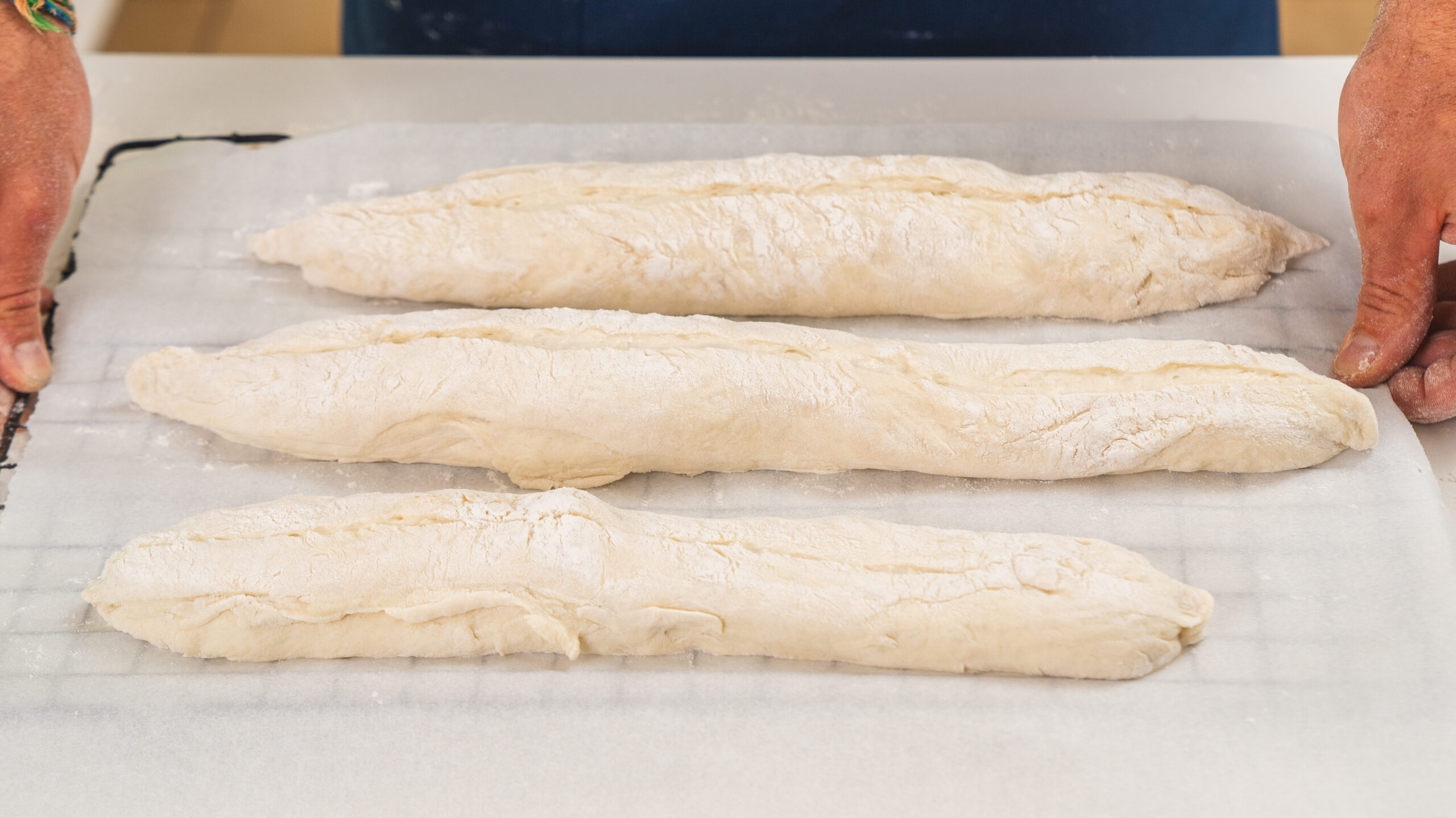 Homemade French baguettes, sitting on a baking sheet, ready for the oven!