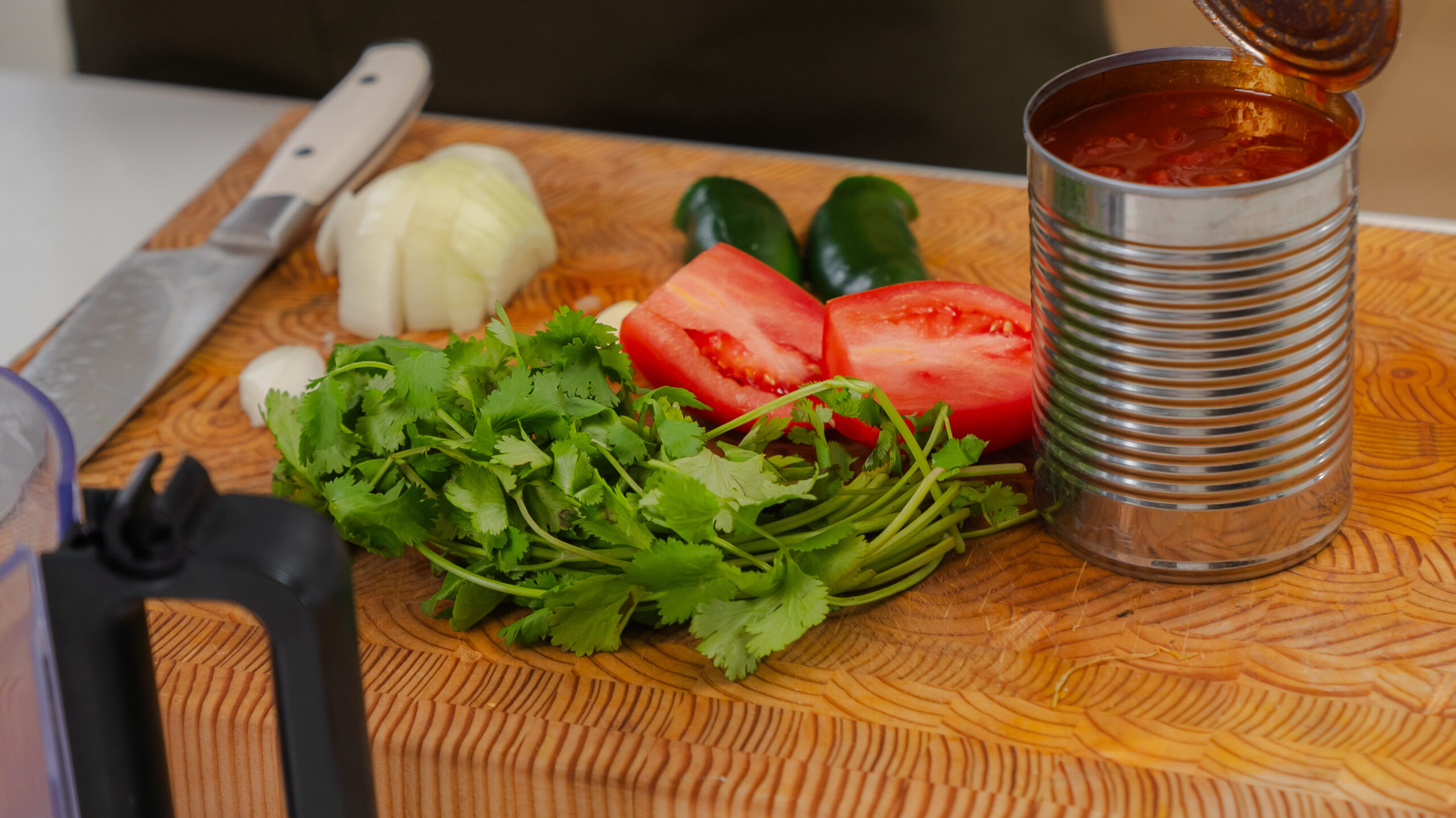 Homemade salsa ingredients in a cutting board.